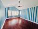 Blue and white striped bedroom with hardwood floors and large windows at 5001 Latrobe Dr, Windermere, FL 34786