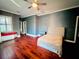 Spacious bedroom with hardwood floors, window seat, and ensuite bathroom at 5001 Latrobe Dr, Windermere, FL 34786