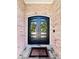 Black double doors flanked by brick and greenery at 5001 Latrobe Dr, Windermere, FL 34786