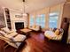 Bright Gathering room with hardwood floors, fireplace, and comfortable seating at 5001 Latrobe Dr, Windermere, FL 34786