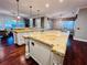 Large kitchen with island, granite countertops, and hardwood floors at 5001 Latrobe Dr, Windermere, FL 34786
