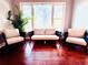 Bright living room with hardwood floors, large windows, and comfortable seating at 5001 Latrobe Dr, Windermere, FL 34786
