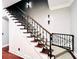 Modern staircase with wrought iron railing and wood steps at 5001 Latrobe Dr, Windermere, FL 34786