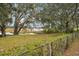 Large backyard with lake view, partially fenced, and lush greenery at 5032 River Lake Rd, Winter Haven, FL 33884