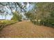 Private backyard with a view of the house and surrounding nature at 5032 River Lake Rd, Winter Haven, FL 33884