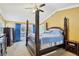 Spacious main bedroom with a post bed and access to balcony at 5032 River Lake Rd, Winter Haven, FL 33884