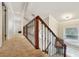 Upstairs hallway with plush carpeting and an ornate railing at 5032 River Lake Rd, Winter Haven, FL 33884