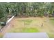 Aerial view showing a large backyard and surrounding trees at 606 Urick St, Fruitland Park, FL 34731