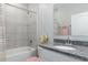 Clean bathroom with granite countertop, tiled shower and bathtub at 606 Urick St, Fruitland Park, FL 34731