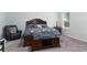 Spacious bedroom with a wooden bed frame and grey carpet at 606 Urick St, Fruitland Park, FL 34731