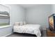 Bedroom with a double bed, window with blinds and carpet flooring at 606 Urick St, Fruitland Park, FL 34731