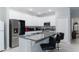 Modern kitchen with white cabinets, granite countertops, and stainless steel appliances at 606 Urick St, Fruitland Park, FL 34731
