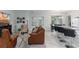 Living room with brown sofas, a large TV, and fireplace at 606 Urick St, Fruitland Park, FL 34731