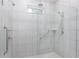 Large walk-in shower with modern fixtures and grab bars at 606 Urick St, Fruitland Park, FL 34731
