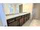 Bathroom with granite countertops and double sinks at 6554 Rover Way, St Cloud, FL 34771