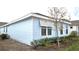 Side view of light blue house with landscaping at 6554 Rover Way, St Cloud, FL 34771