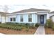 Light blue house with a blue door and landscaping at 6554 Rover Way, St Cloud, FL 34771
