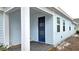 House exterior showcasing a blue front door and porch at 6554 Rover Way, St Cloud, FL 34771