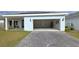 Charming house exterior featuring a two-car garage and brick paver driveway at 6554 Rover Way, St Cloud, FL 34771