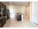 Open kitchen with island and granite countertops at 6554 Rover Way, St Cloud, FL 34771