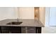 Kitchen island with granite countertop and sink at 6554 Rover Way, St Cloud, FL 34771