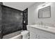 Clean bathroom with dark tile shower and white vanity at 67 Sabal Cay Court, New Smyrna Beach, FL 32169