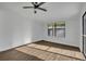 Bright bedroom with wood-look floors and large window at 67 Sabal Cay Court, New Smyrna Beach, FL 32169