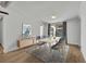 Modern dining room with light wood table, stylish chairs, gray rug, and a sliding glass door at 67 Sabal Cay Court, New Smyrna Beach, FL 32169