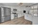 Modern white kitchen with stainless steel appliances and an island at 67 Sabal Cay Court, New Smyrna Beach, FL 32169