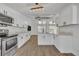 Modern white kitchen with stainless steel appliances and an island at 67 Sabal Cay Court, New Smyrna Beach, FL 32169
