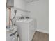 Laundry room with washer, dryer, and overhead shelving at 67 Sabal Cay Court, New Smyrna Beach, FL 32169