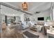Open-concept living room and dining area with wood-look floors, a modern ceiling, and bright interior at 67 Sabal Cay Court, New Smyrna Beach, FL 32169