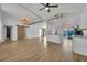 Open concept living room, kitchen, and island with wood-look floors at 67 Sabal Cay Court, New Smyrna Beach, FL 32169