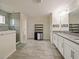 Large bathroom with double vanity, walk-in shower, and gray tile floor at 7043 Oxbow Rd, Minneola, FL 34715
