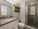 Modern bathroom with walk-in shower and gray tile at 7043 Oxbow Rd, Minneola, FL 34715
