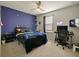 Spacious bedroom with a gaming setup and a comfortable bed at 7043 Oxbow Rd, Minneola, FL 34715