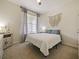 Cozy bedroom with carpeted floor and large window at 7043 Oxbow Rd, Minneola, FL 34715