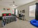 Bright bedroom with a bed, desk and a beanbag chair at 7043 Oxbow Rd, Minneola, FL 34715