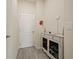 Bright entryway with a white cabinet and gray tile floor at 7043 Oxbow Rd, Minneola, FL 34715