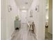 Light and bright entryway with tile flooring and storage bench at 7043 Oxbow Rd, Minneola, FL 34715
