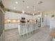 Open kitchen with large island, white cabinets and stainless steel appliances at 7043 Oxbow Rd, Minneola, FL 34715