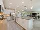 Open kitchen with large island, white cabinets and stainless steel appliances at 7043 Oxbow Rd, Minneola, FL 34715