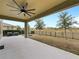 Covered patio overlooking a fenced backyard and trees at 7043 Oxbow Rd, Minneola, FL 34715