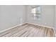 Spacious bedroom featuring wood-look floors and large window at 7135 Yacht Basin Ave # 228, Orlando, FL 32835