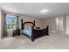 Bright bedroom with window and nightstand at 8060 Bowery Dr, Winter Garden, FL 34787