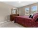 Cozy bedroom with double bed and two windows at 8060 Bowery Dr, Winter Garden, FL 34787