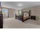 Large bedroom with carpeted floors and a dark wood bed frame at 8060 Bowery Dr, Winter Garden, FL 34787