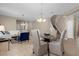 Dining area with glass table and beige chairs near living room at 8060 Bowery Dr, Winter Garden, FL 34787