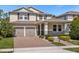 Two-story house with a two-car garage and neatly landscaped front yard at 8060 Bowery Dr, Winter Garden, FL 34787