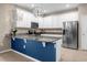 Modern kitchen with white cabinets, granite countertops and blue island at 8060 Bowery Dr, Winter Garden, FL 34787